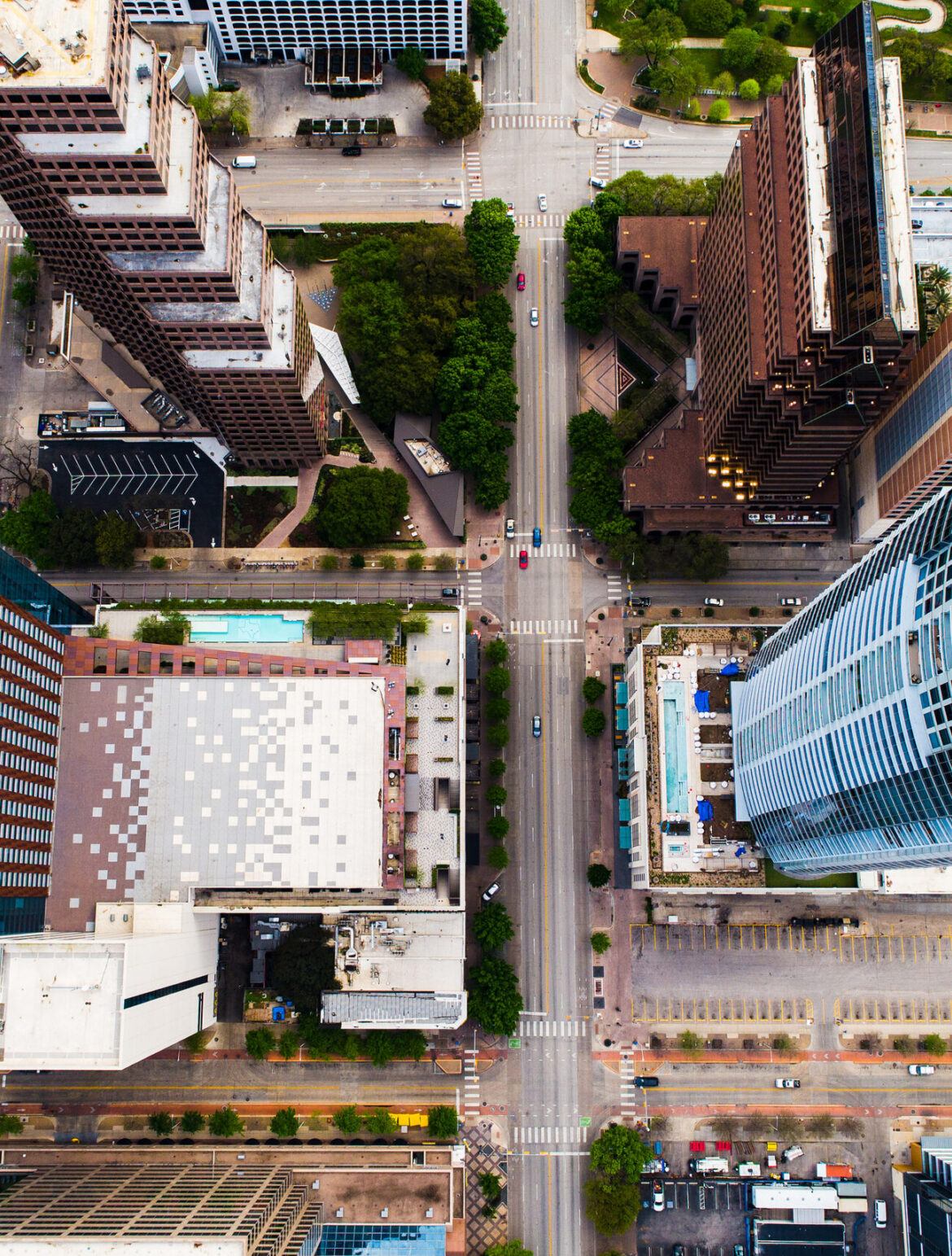 Straight down drone views of Town Lake and Tall Skyscrapers and straight down above roads , aerial drone views of austin texas skyline cityscape sunny afternoon amazing views down Congress avenue and downtown views of skyscrapers