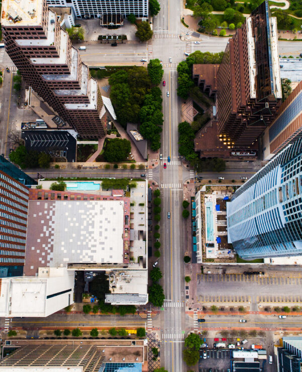 Straight down drone views of Town Lake and Tall Skyscrapers and straight down above roads , aerial drone views of austin texas skyline cityscape sunny afternoon amazing views down Congress avenue and downtown views of skyscrapers